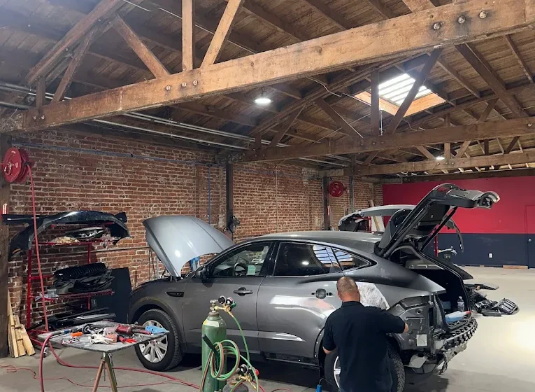 Technician performing collision repair at Apple Collision Koreatown